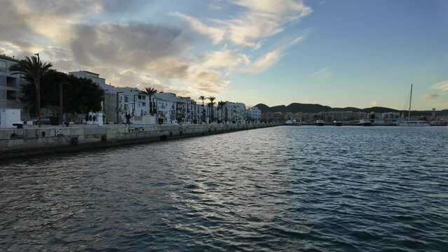 Ibiza city downtown in a cold winter day. Motionlapse left to right before sunset with some clouds in the sky. 4K