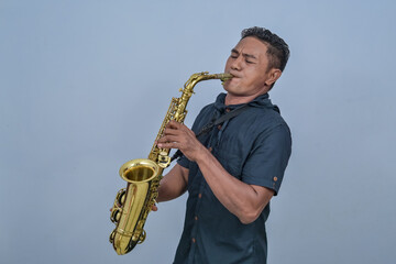 A man is playing the Saxophone