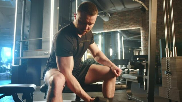 A man with a focused expression performing a bicep curl on a gym bench, exhibiting commitment to his strength workout routine. Camera 8K RAW. 