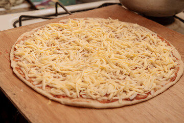 Homemade pizza with love from his father for his family. Pizza with ham and pineapple. Exquisite and tasty.