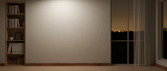 The interior design of a contemporary room at night with a wall and dim light from a pendant light.