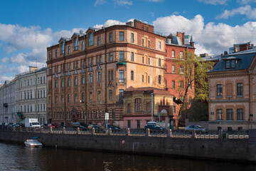View of a residential building on the Moika River embankment on a sunny day, Saint Petersburg, Russia