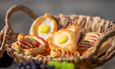 baked buns in a basket on an outdoor table - 763712016
