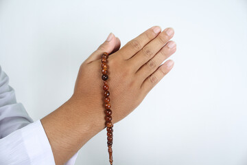 close up of muslim hands posing greeting with holding prayer bead isolated