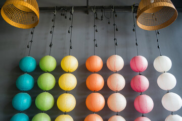 Hanging colorful Japanese lantern on row with dark background. Handcrafted lampshades.