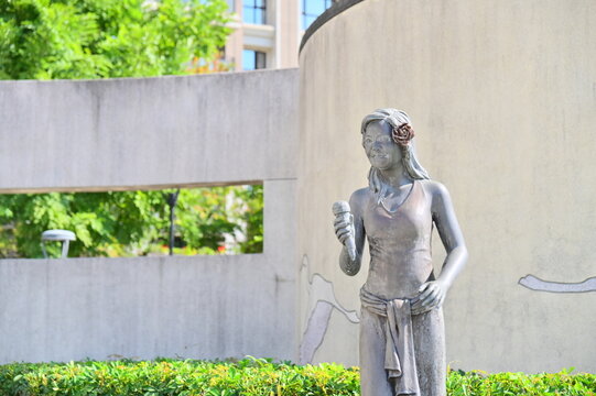 A close-up of the Teresa Teng Memorial Statue at Luzhou MRT Station in Sunlight Park during the day.