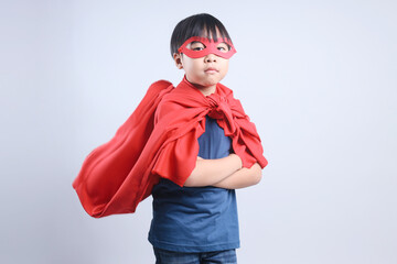 Portrait of Asian Boy Wearing Superhero Costume and Standing Confidently Isolated on Gray Background
