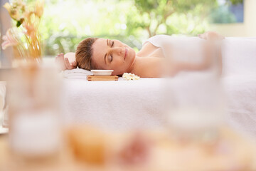 Obraz na płótnie Canvas Woman, relax and sleeping with towel at spa in stress relief, zen or health and wellness on massage table. Calm female person enjoying luxury skincare, body treatment or relaxation at peaceful resort