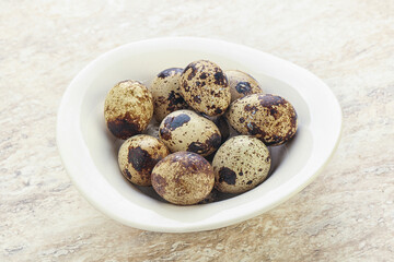 Raw quail eggs heap in the bowl