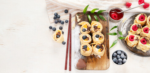 Asian sweet sushi pancake. Rolls with cream cheese berry and fruits.