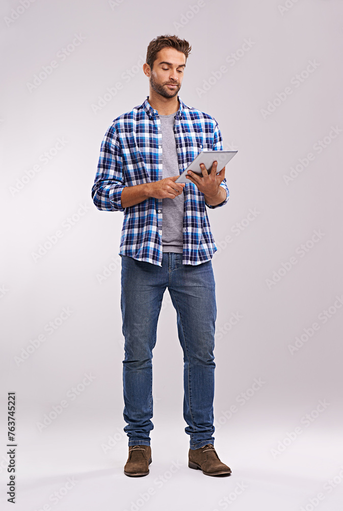 Poster typing, tablet or man with connection, thinking or digital app on a grey studio background with soci