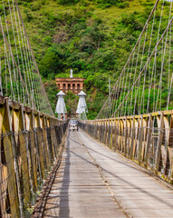 Tuk tuk car crossing the iconic Western Bridge, a symbol of Santa Fe de Antioquia