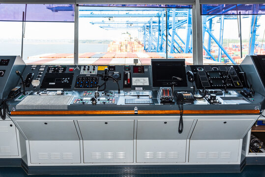 View of the control console on the navigational bridge of the cargo container ship.