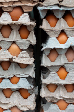 Stacked Egg Cartons with Brown Eggs at Traditional Market in Indonesia
