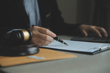 Business and lawyers discussing contract papers with brass scale on desk in office. Law, legal services, advice, justice and law concept picture with film grain effect