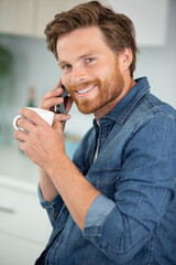 young man wearing casual clothes talking on a mobile phone