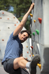 young and fit man exercises free mountain climbing