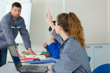 young woman in auto mechanics training class