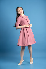 Full body image of female businessman posing on a blue background