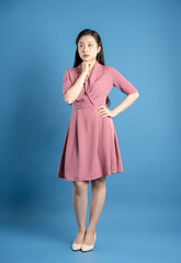 Full body image of female businessman posing on a blue background