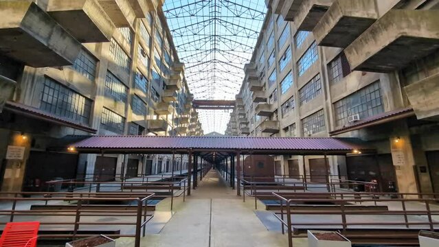 view looking up at balconies in the atrium of the brooklyn army terminal warehouse building (world war two military shipping train yard) balcony bleak