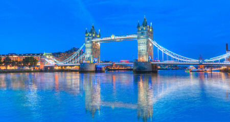 Panorama of the Tower Bridge and Tower of London on Thames river at twilight blue hour  - London England
