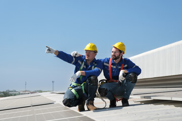 Engineers install solae cell on the roof of factory