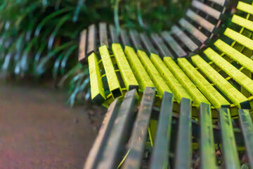 This is a bench with a curved design found on a walking trail.