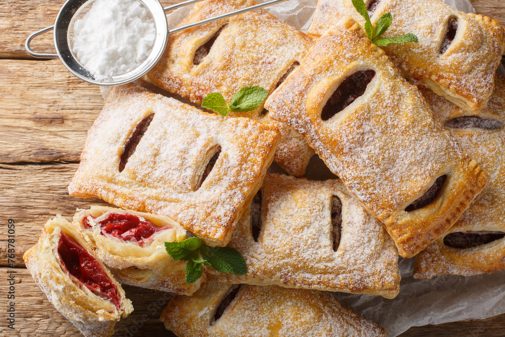 Canvas Prints sweet berry puff pastry with powdered sugar and mint close-up on the table. horizontal top view from