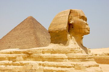 A close-up view of the famous Sphinx of Giza, with the Great Pyramid in the background, in Cairo, Egypt.