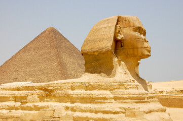 A close-up view of the famous Sphinx of Giza, with the Great Pyramid in the background, in Cairo,...