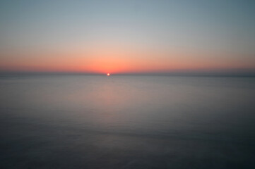 Sunrise seascape with sun light reflection
