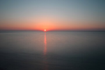 Sunrise seascape with sun light reflection