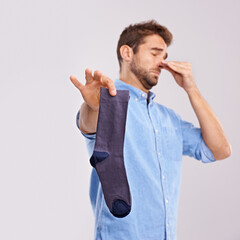 Man, smelly socks and close nose for poor hygiene with clothes, bad odor or stink with disgust...