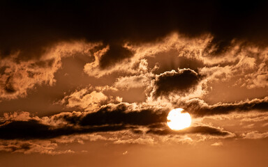 An impressive cloudy sundown orange sky. Space for your text and logo.