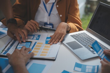 Close up ux developer and ui designer use augmented reality brainstorming about mobile app interface wireframe design on desk at modern office.Creative digital development agency