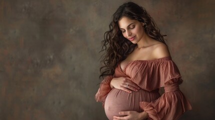 Naklejka premium Young pregnant woman against the dark studio background. Waiting for the birth of a child