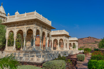 Three white small temple and the Jaswant Thada mausoleum in Jodhpur, Rajasthan, India
