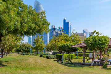 beautiful green Corniche park in Abu Dhabi, UAE overlooking the skyscrapers of the business center