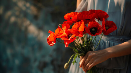 Beautiful woman hands holding a bouquet of red poppy flowers background as a symbol of both remembrance and hope for a peaceful future with copy space - obrazy, fototapety, plakaty