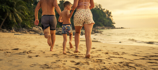 family running on the tropical beach in Phuket island