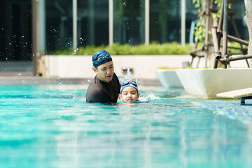 Father and son enjoy swimming together on their vacation.