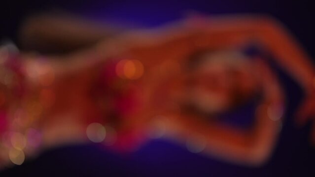 Dancer with long hair in bright oriental costume dancing belly dance 