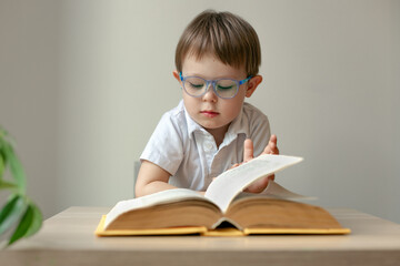 boy wearing glasses reading a book, book lover concept, learn to read