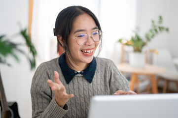 A smart, cheerful young Asian female college student is presenting her project via an online meeting