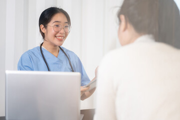 Fototapeta premium A professional Asian female doctor is consulting a female patient in the office at the hospital.