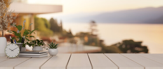 A space on a tabletop features decoration with a blurred background of an outdoors villa space.