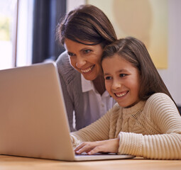 Fototapeta premium Happy mother, child and learning with laptop for support, care or browsing on social media at home. Mother, daughter or young kid typing on computer for reading or helping girl on project or homework