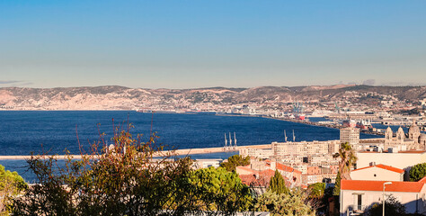 Panoramic view of Marseille from top Notre Dame de la Garde hill. City skyline with houses, streets...
