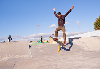 Fitness, freedom and man with skateboard, jump or rail balance at a skate park for stunt training....